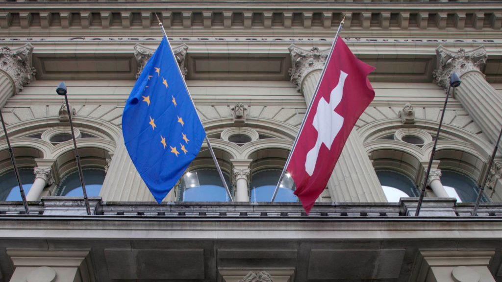 The flags of Switzerland and the EU adorn the Federal Palace.