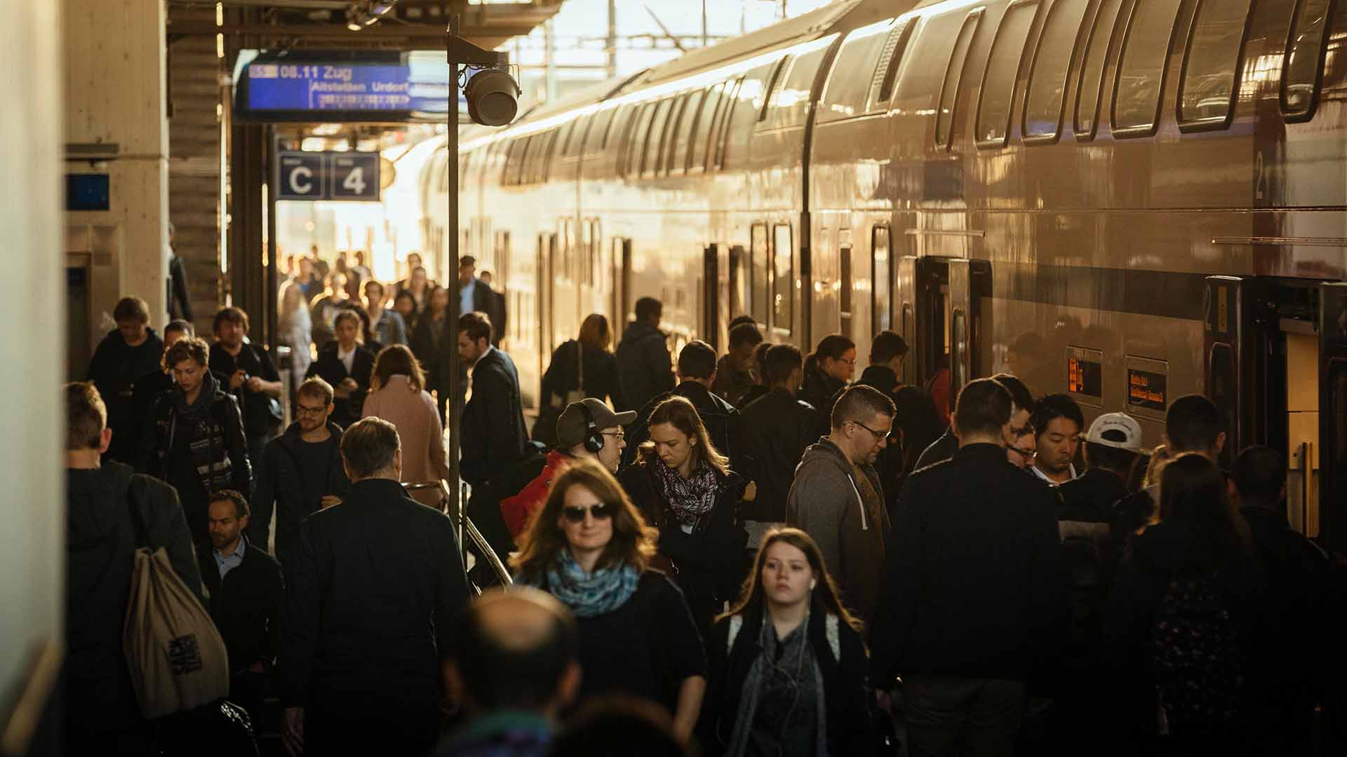 Passengers disembarking from a double-decker train.